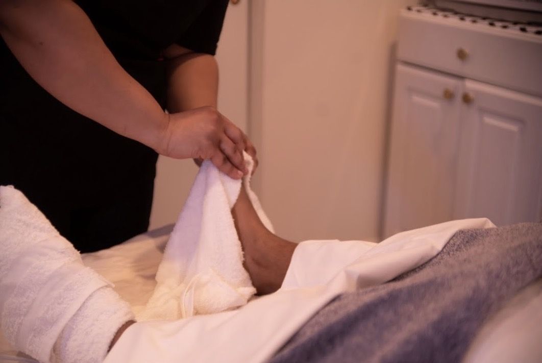 Nedra working with a client’s foot during an individualized session